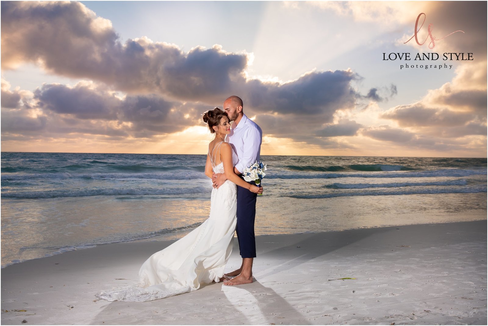 Bride and Groom walking on Bradenton Beach at sunset  in front of The Beach House Restaurant