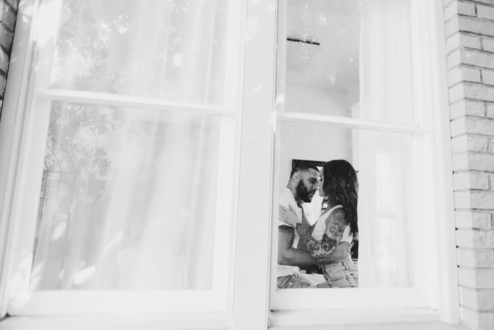 intimate-couple-in-window