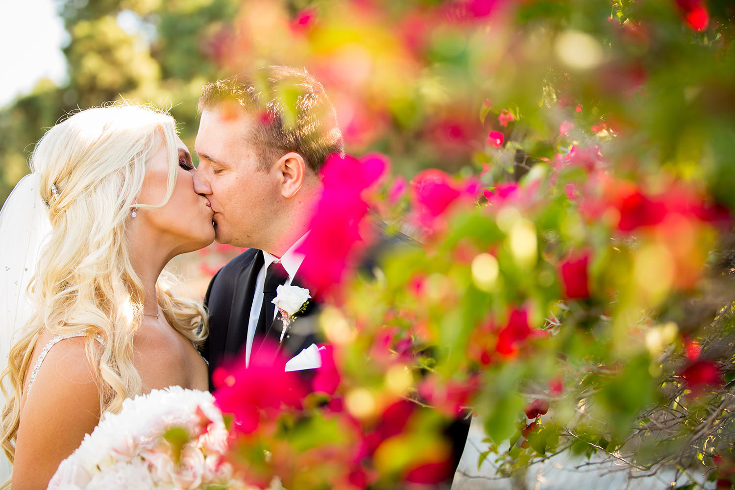 bride and groom kissing with flowers romantic