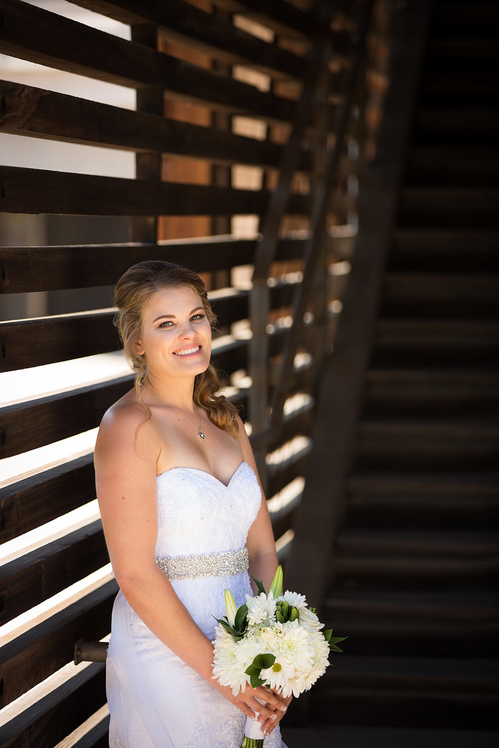 bride smiling with stairs at artin johnson house