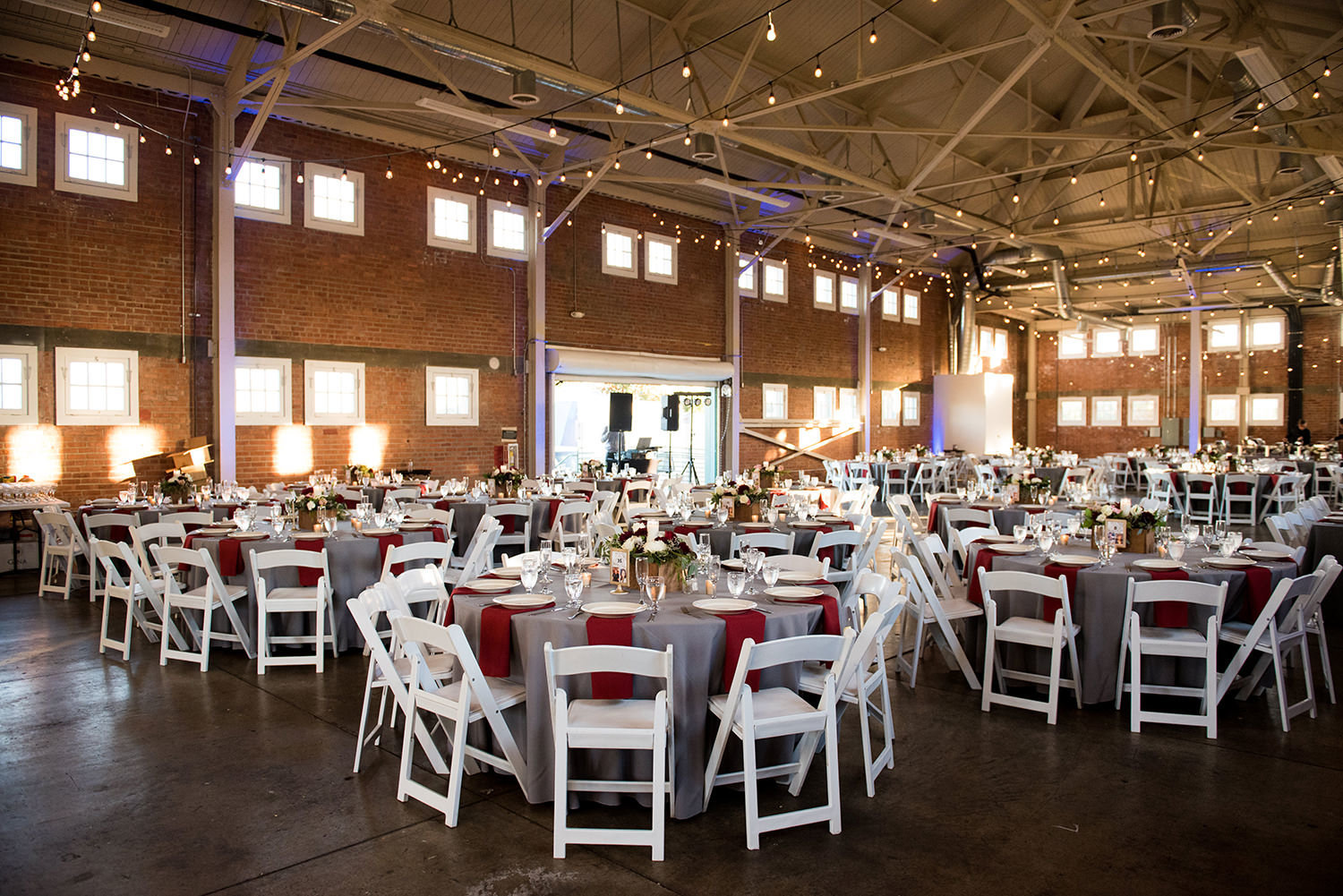 beautiful photo of reception room at brick round tables