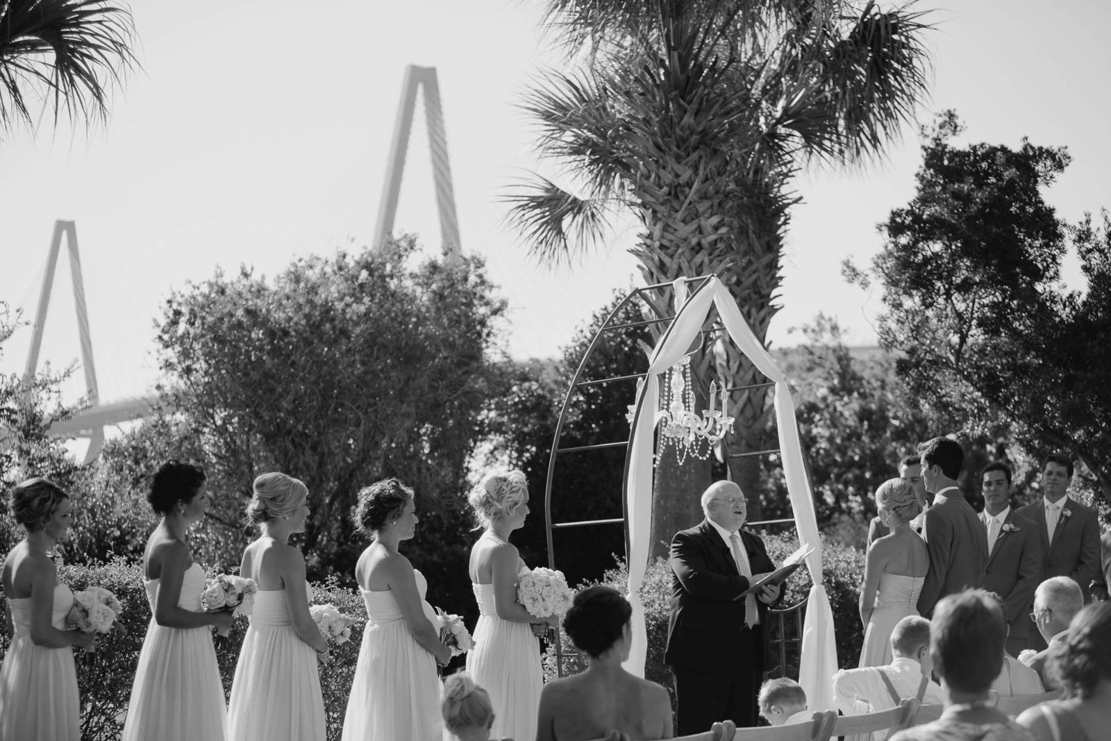 Bride and groom exchange vows with Ravenel Bridge in background, Harborside East, Mt Pleasant, South Carolina