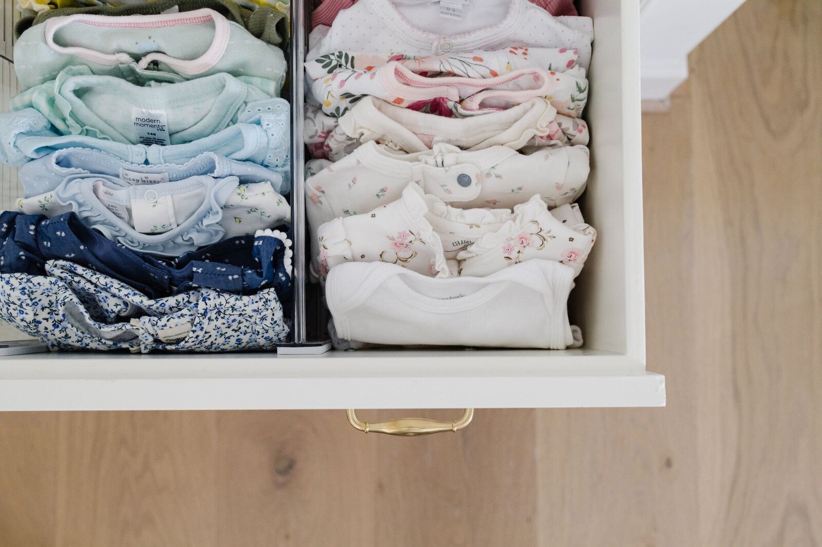 vision and hammer folded baby clothes in drawer