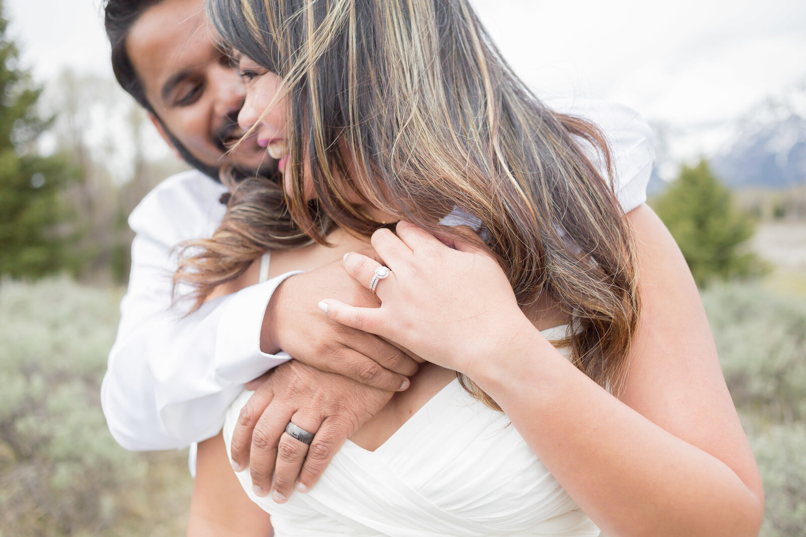 Washington Elopement Photographer captures man hugging woman's neck after PNW wedding