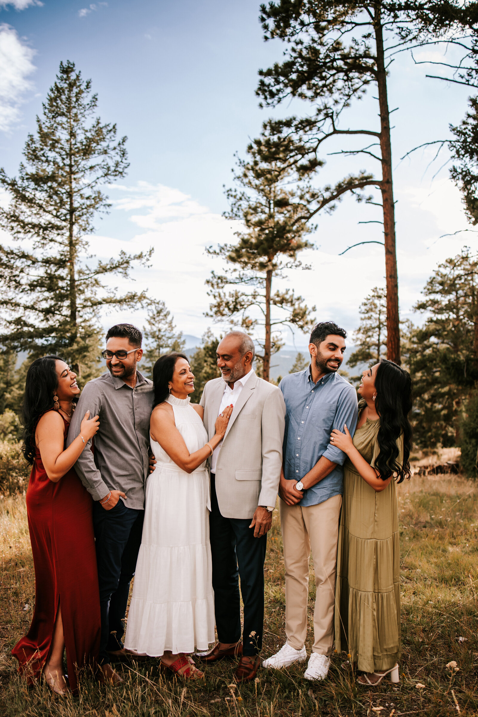 family of six adults in the middle of a forrest in colorado for family photos