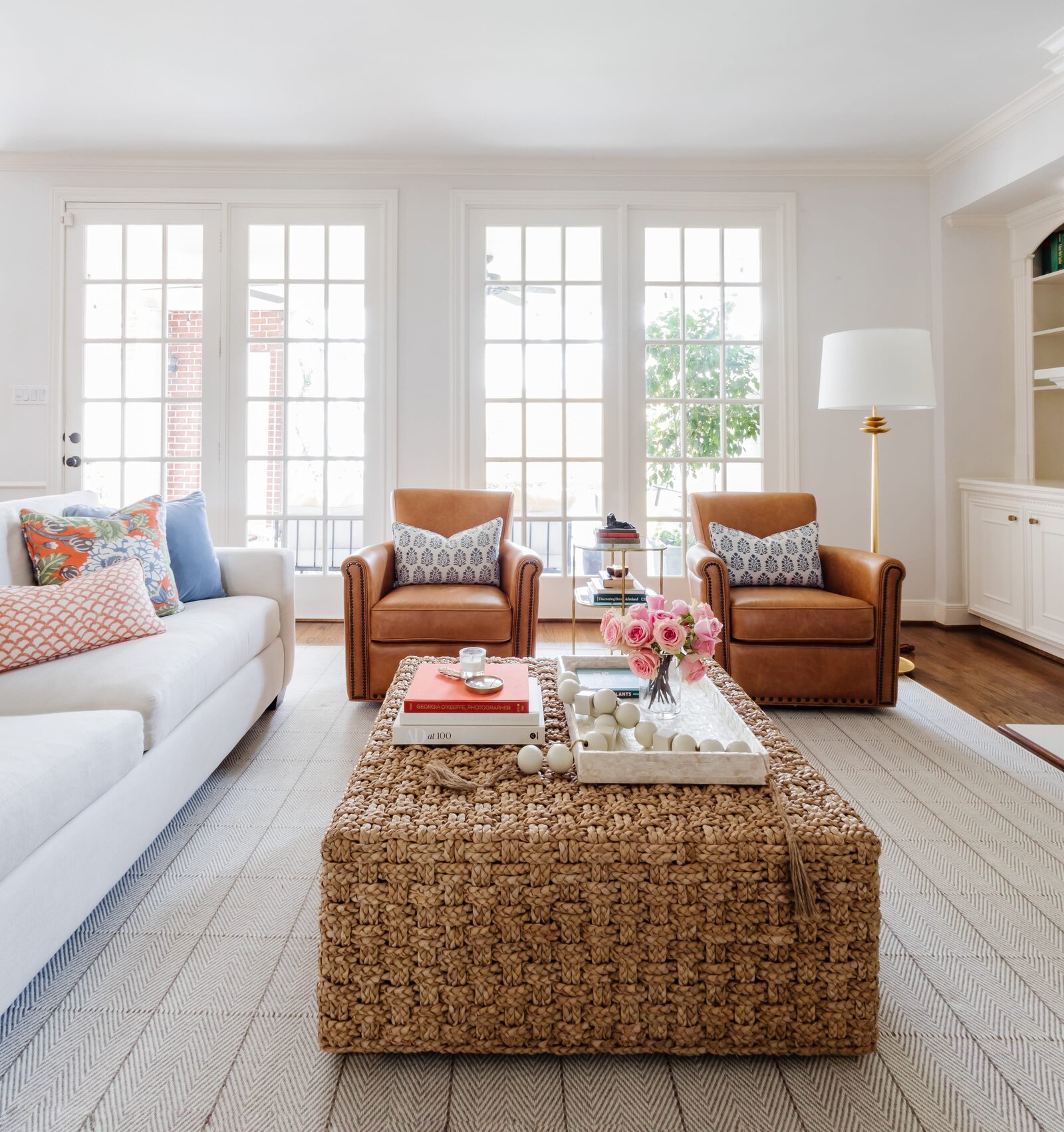 vision and hammer living room with leather chairs and large french doors