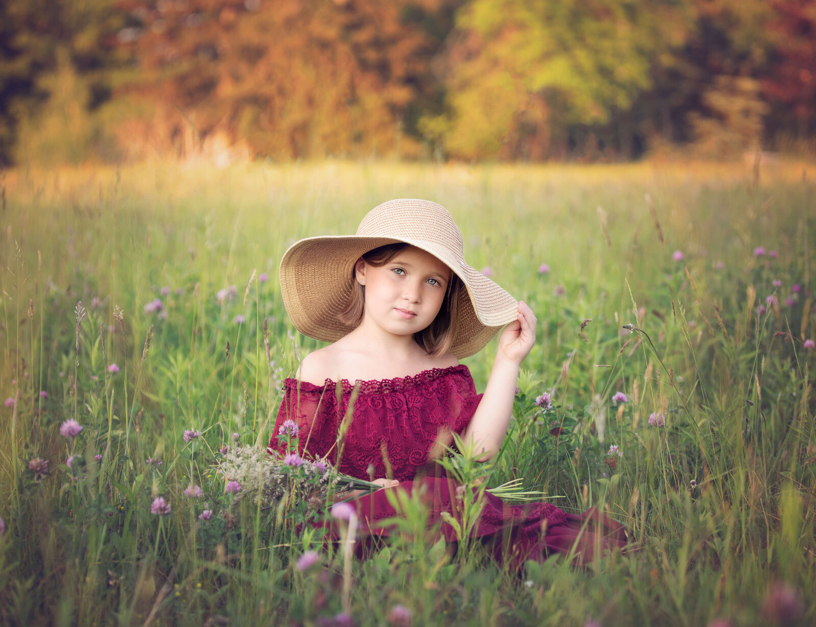 Photo of a little girl sitting in a field in Erie Pa