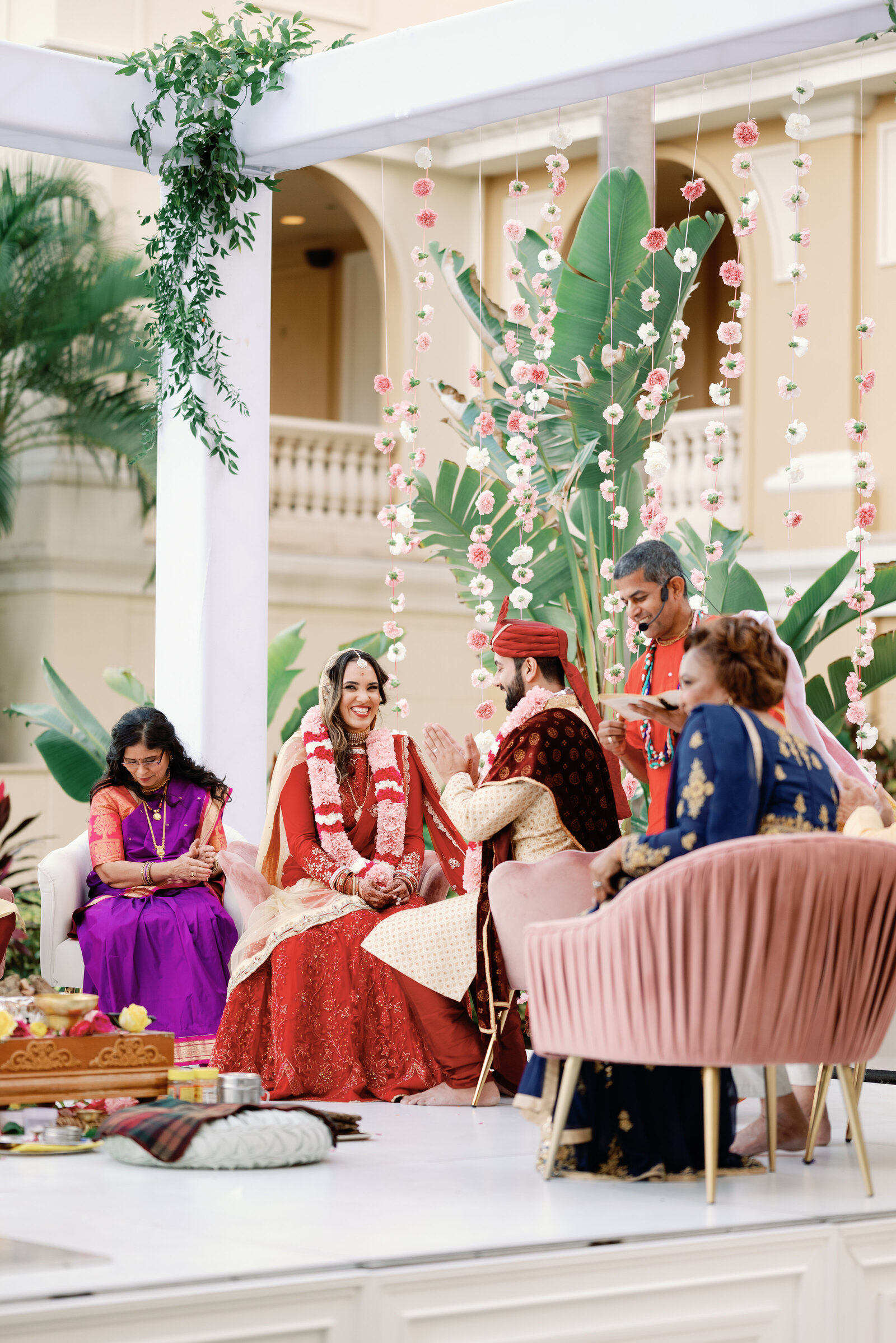 bride and groom seated at the mandap during indian wedding ceremony