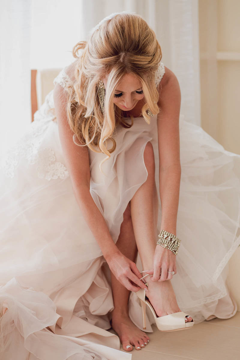 Bride puts on her shoes, Destination wedding, Hyatt Regency, Sarasota, Florida. Kate Timbers Photography.