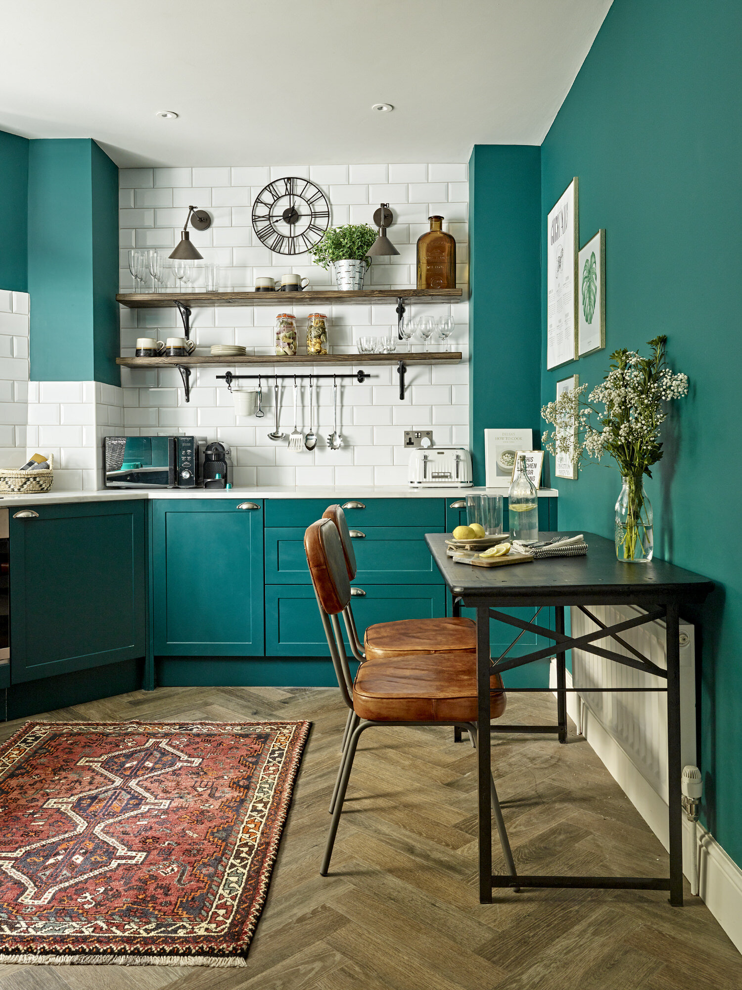 teal green kitchen with wood floors and white tile