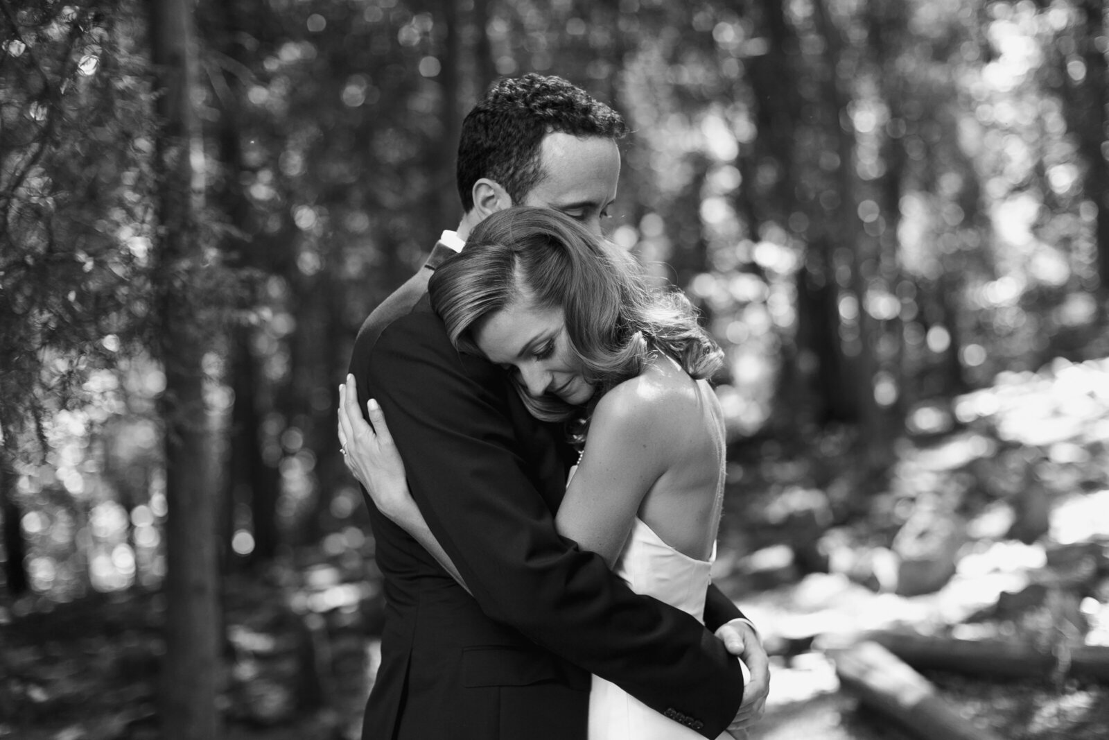 black and white couple hugging in forrest