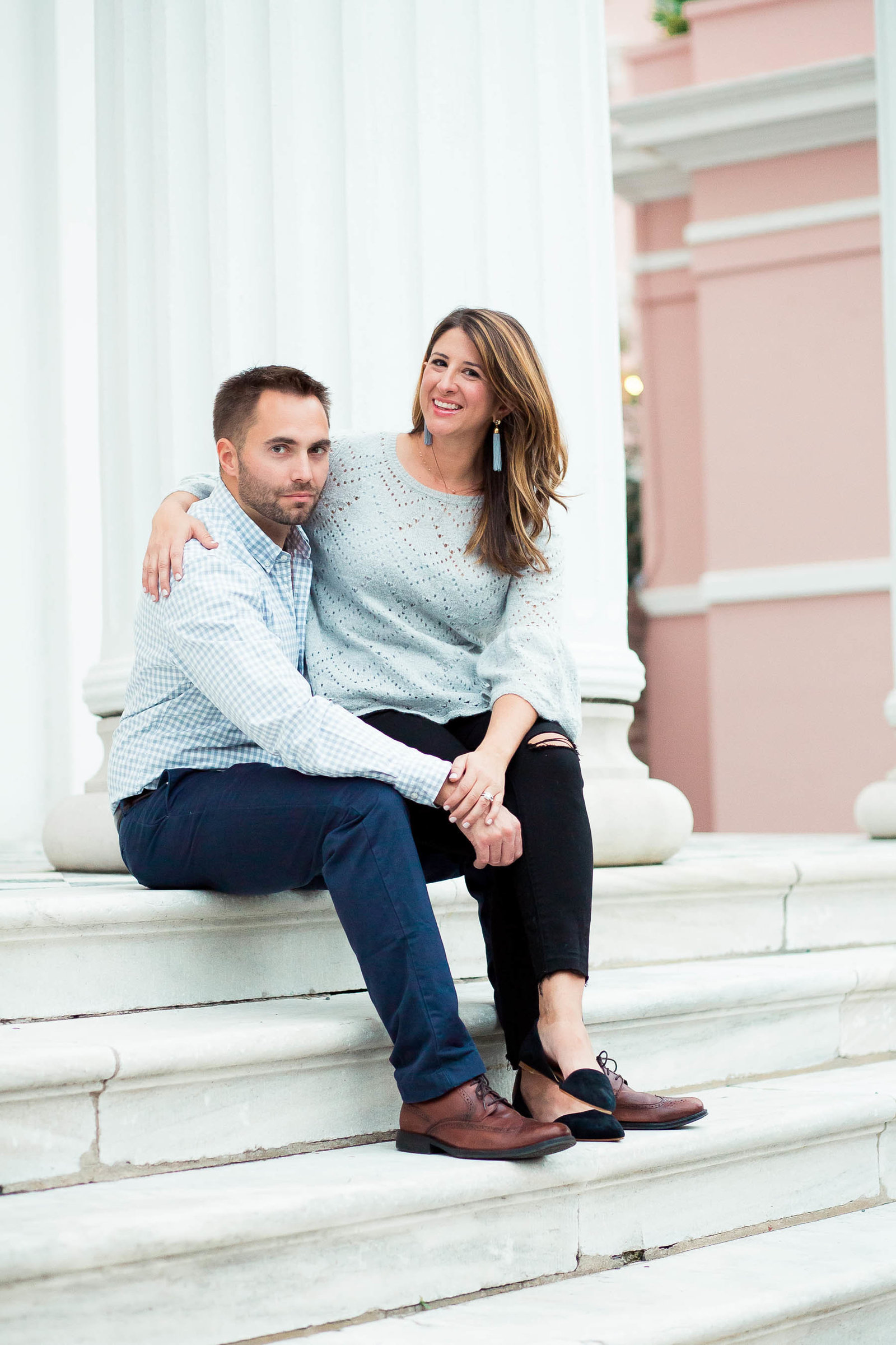 Couple sits on steps of Hibernian Hall for Engagement