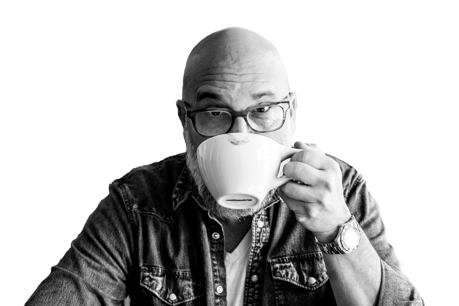 Black and White photo of Sky drinking coffee from a mug while looking at the camera