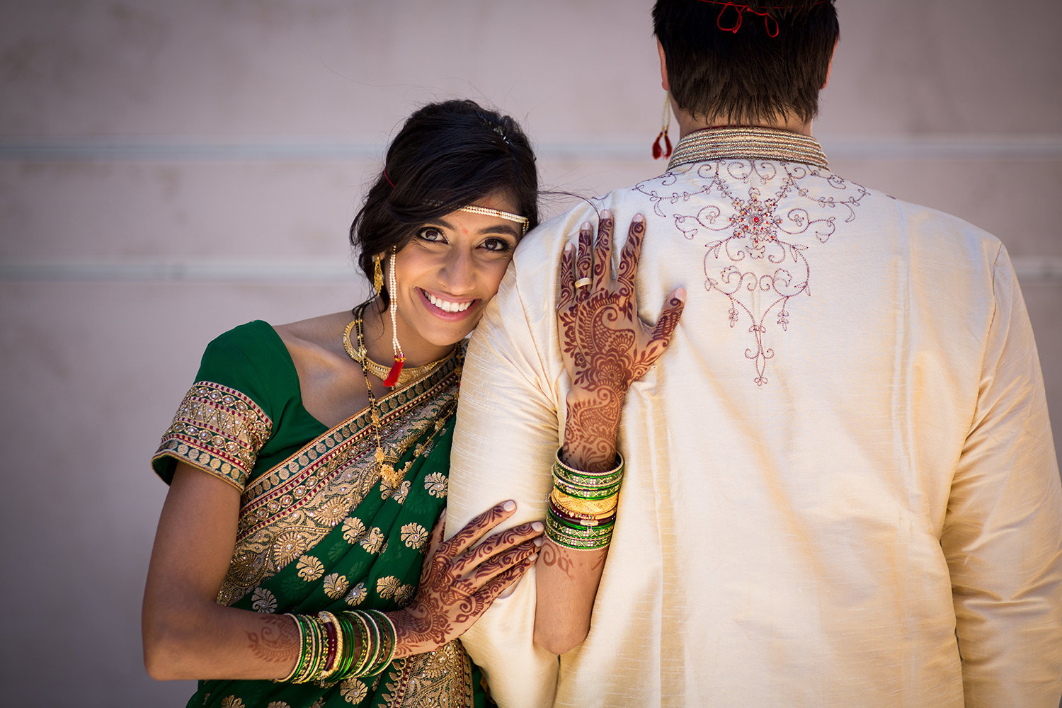 Hindu bride snuggles up with her groom