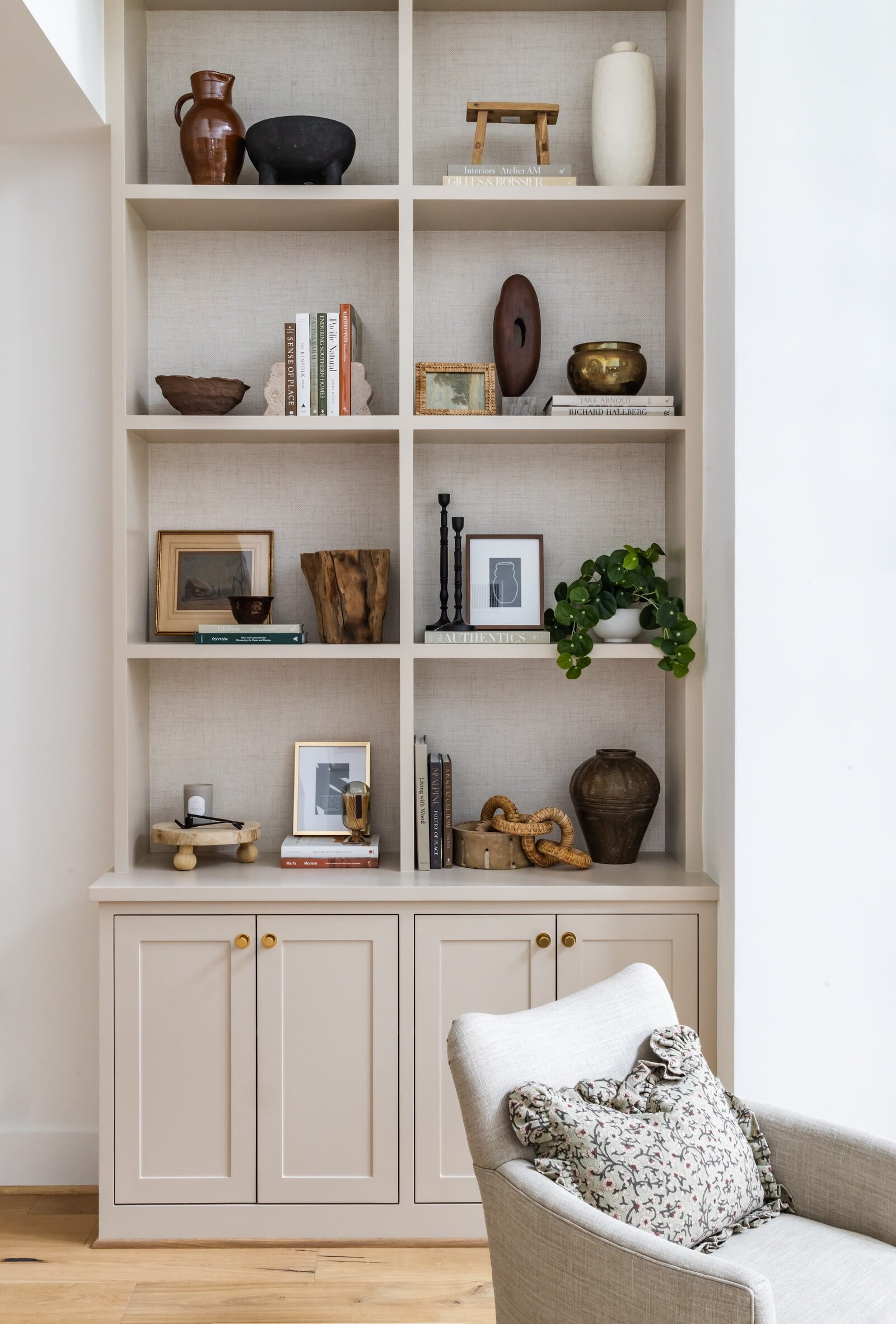 vision and hammer styling shelf on tall tan colored buildin with bookd and wooden accents