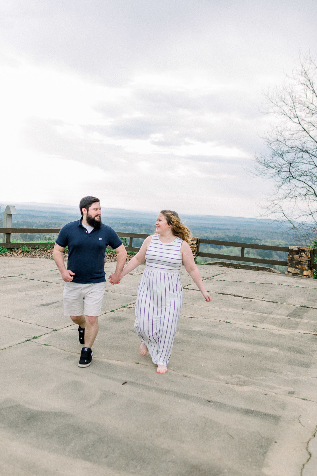 Couple running and laughing captured by Staci Addison Photography