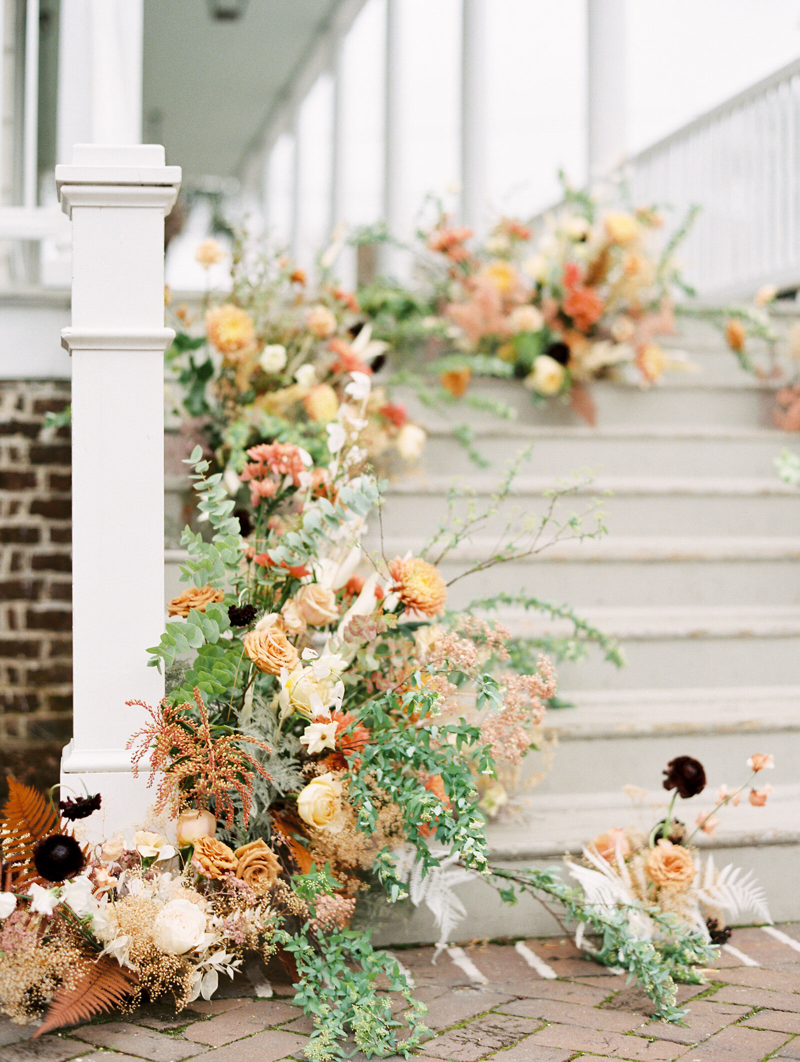 floral arrangement outside on the steps at the gadsden house in charleston south carolina