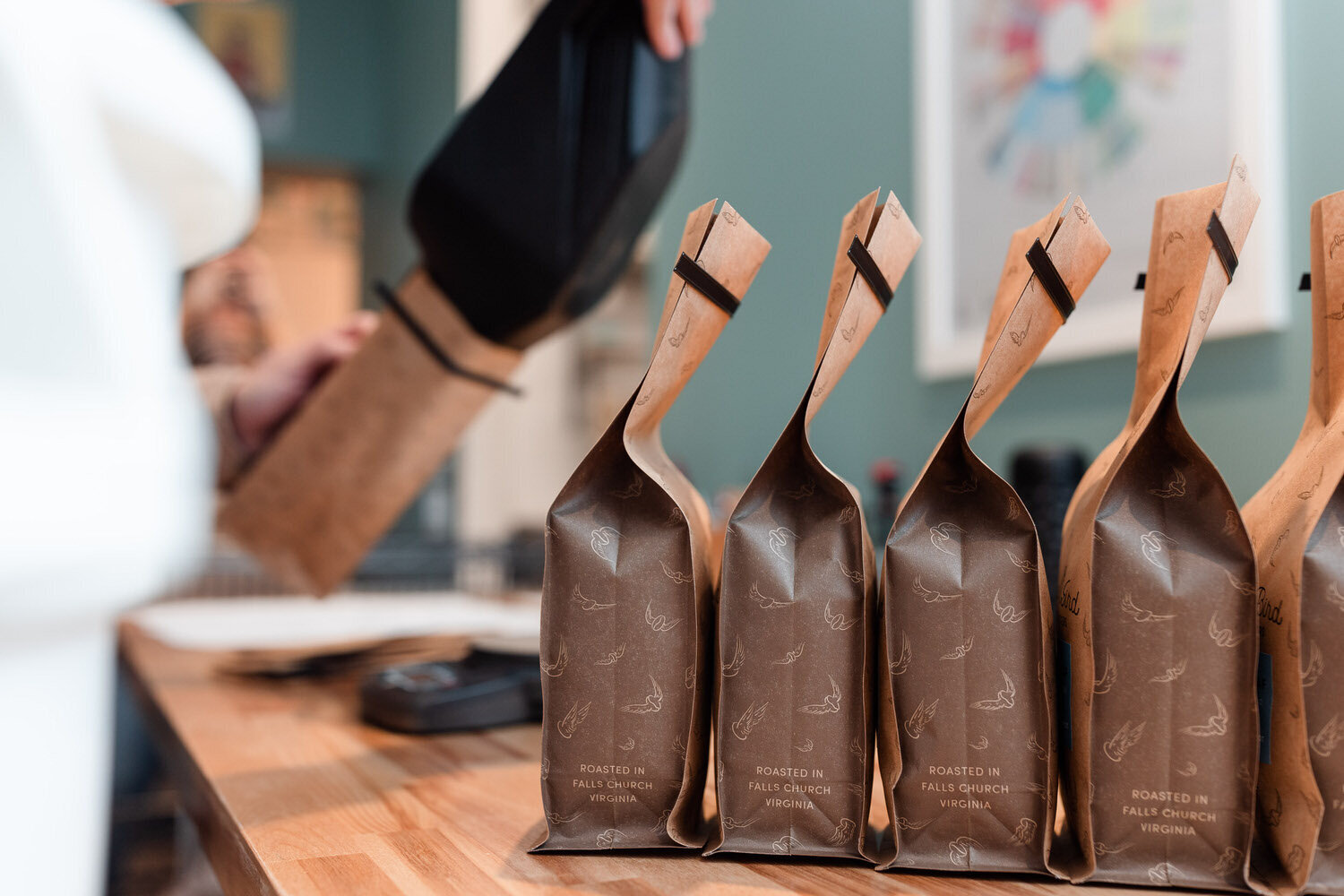 brown bags of coffee lined up on a table