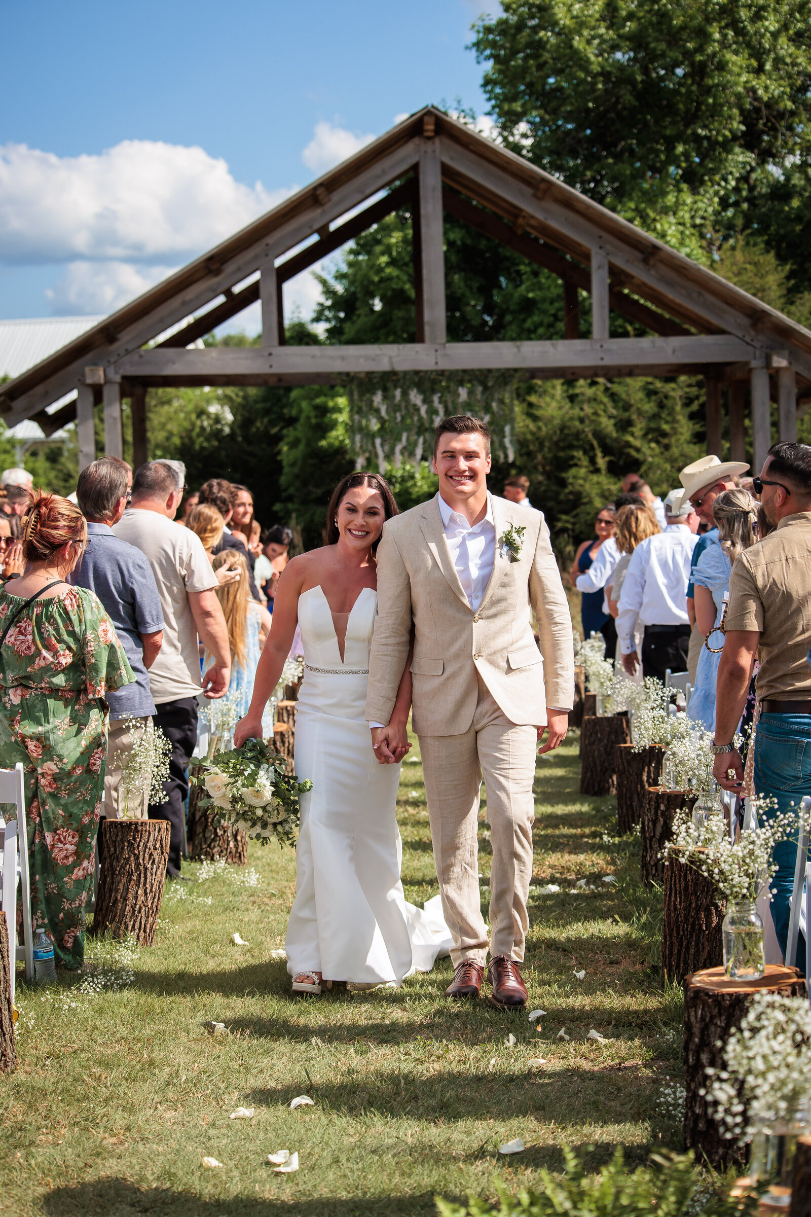 Bride and Groom exiting aisle after ceremony at Stone Hill Barn