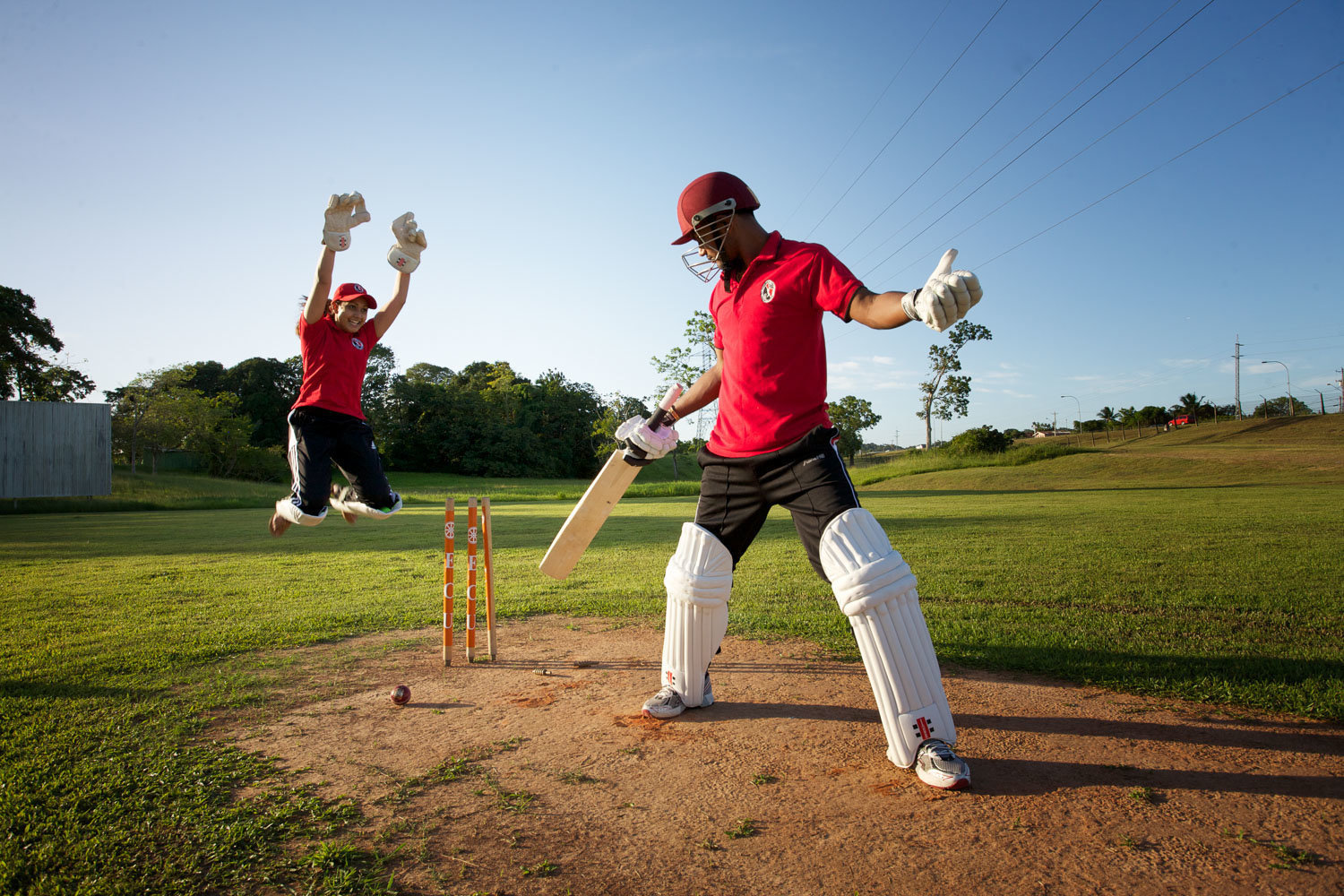 Engaged couple playing cricket. Photo by Ross Photography, Trinidad, W.I..