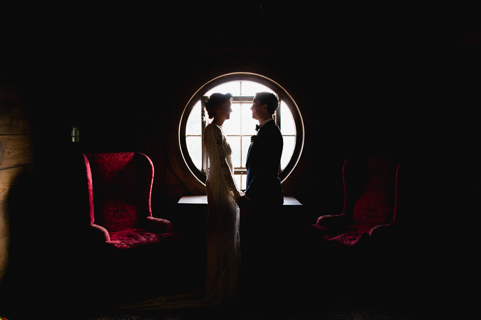 bride and groom silhouetted in window