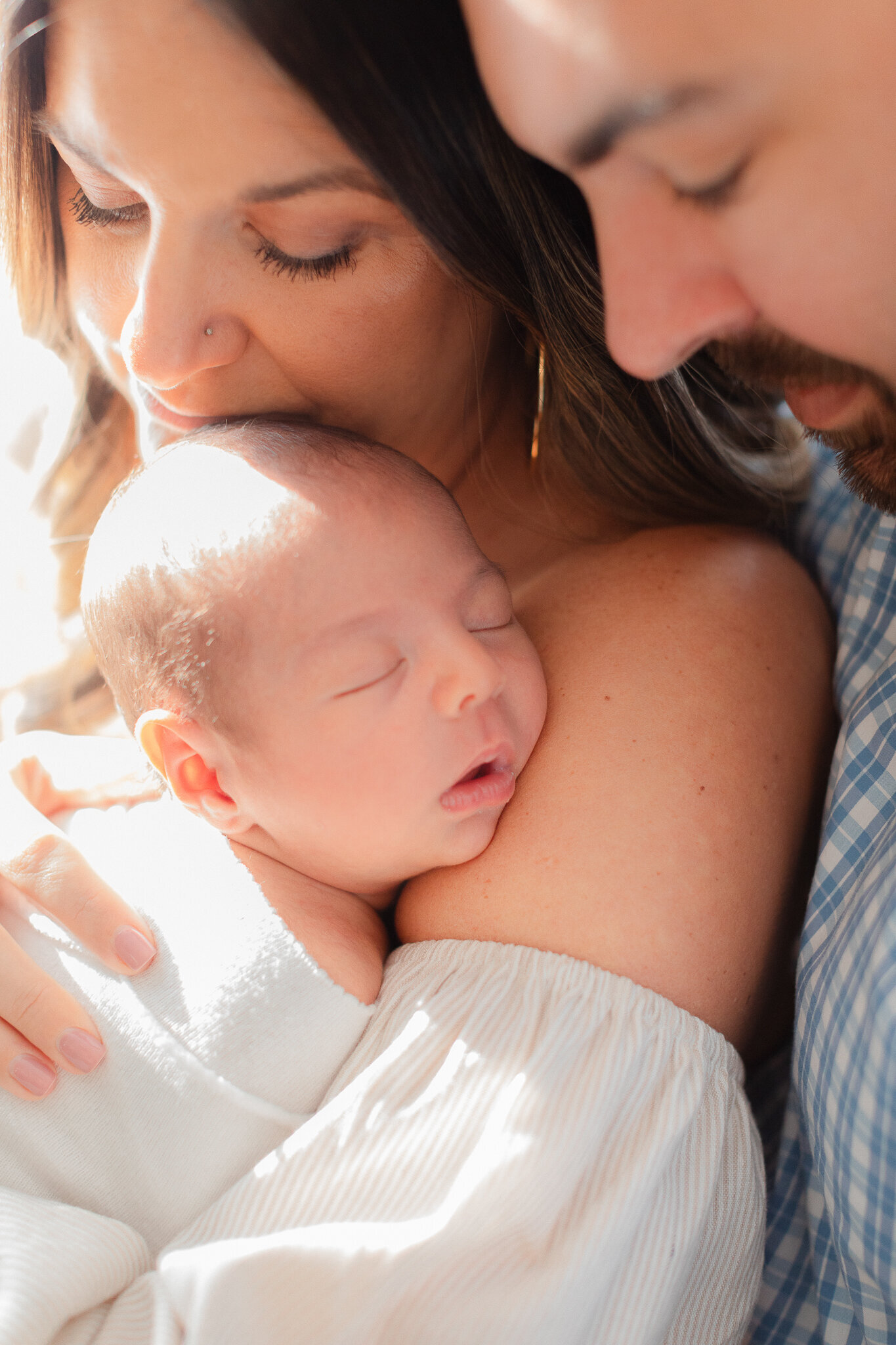 massachusetts newborn photographer close up image of new parents holding baby