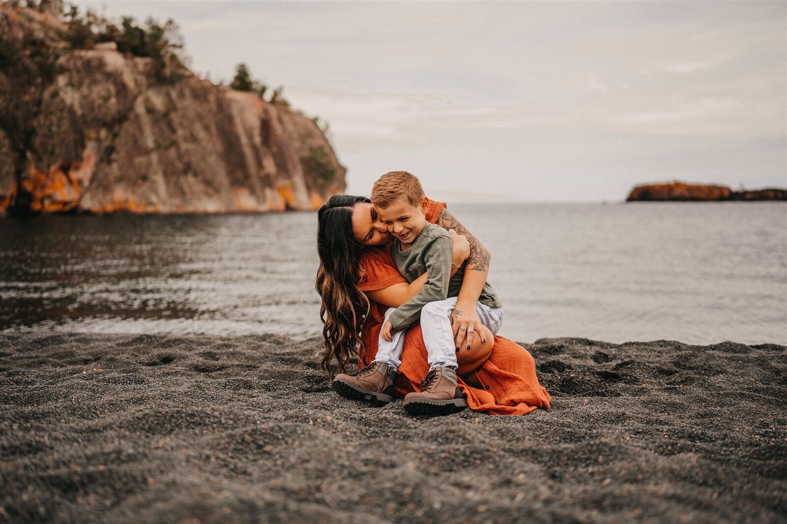 Mother and son enjoy a special moment on the Black Sand Beaches of Duluth