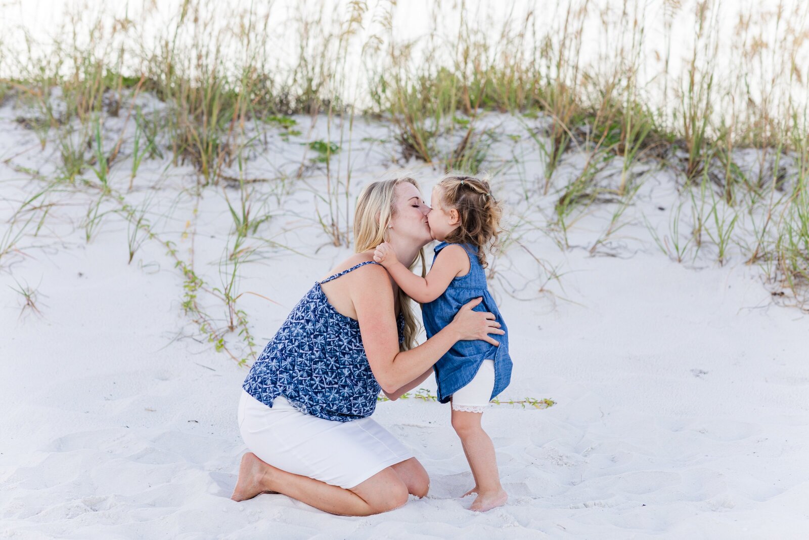 Mother hugging toddler daughter on Pensacola Beach