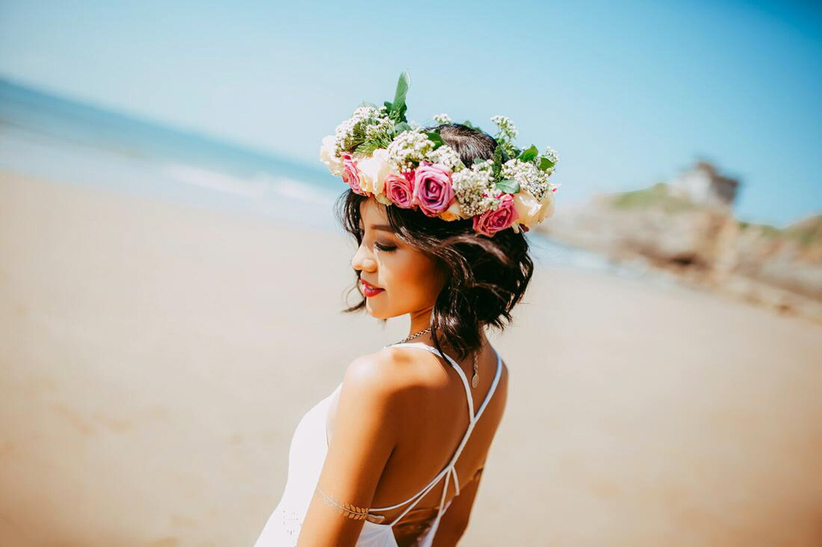 Bride with floral head band on the seashore