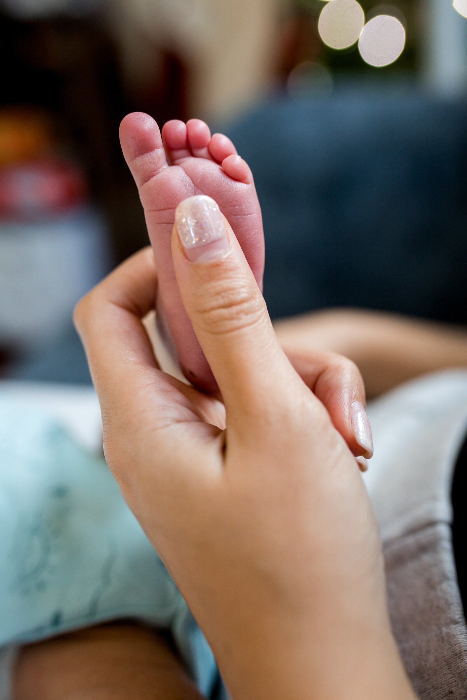Newborn baby foot  with mom's  hand