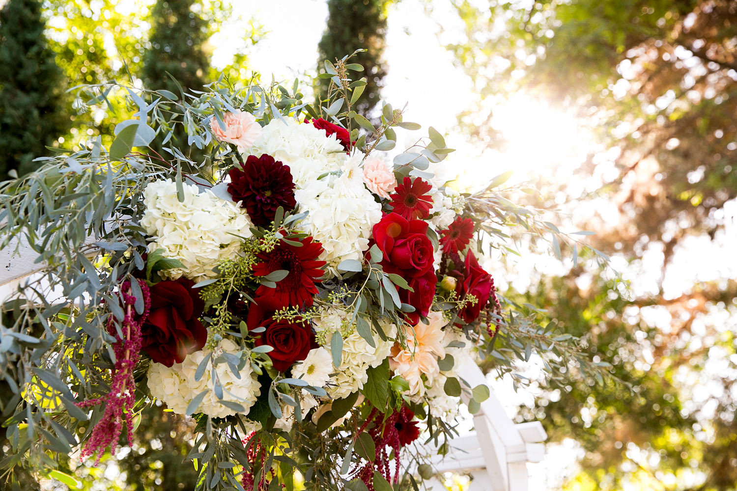 stunning ceremony space at carlton oaks red and white flower arch