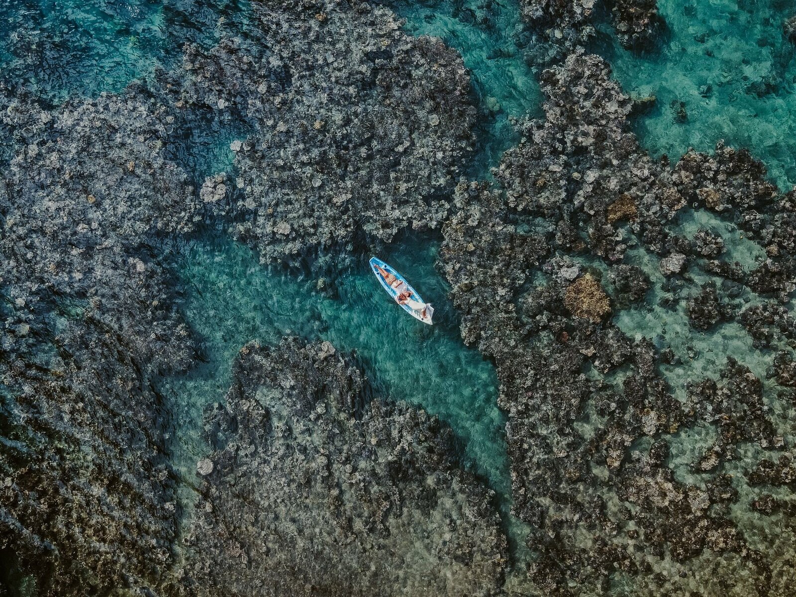couple lying in a kayak after getting married in Vanuatu
