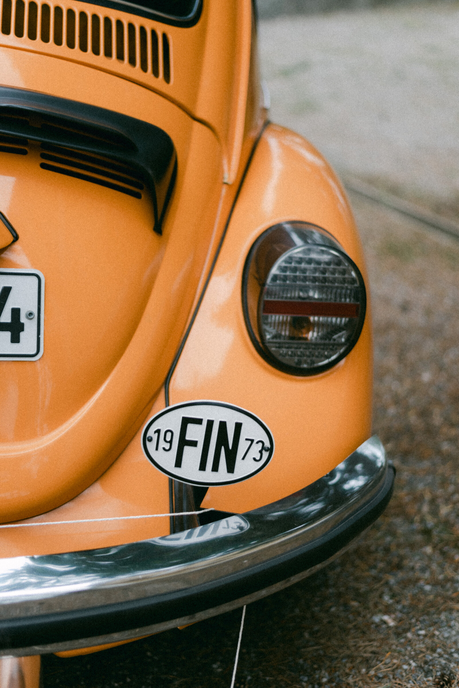 Orange volkswagen beetle as a wedding car. Documentary wedding photograph captured by photographer Hannika Gabrielsson.