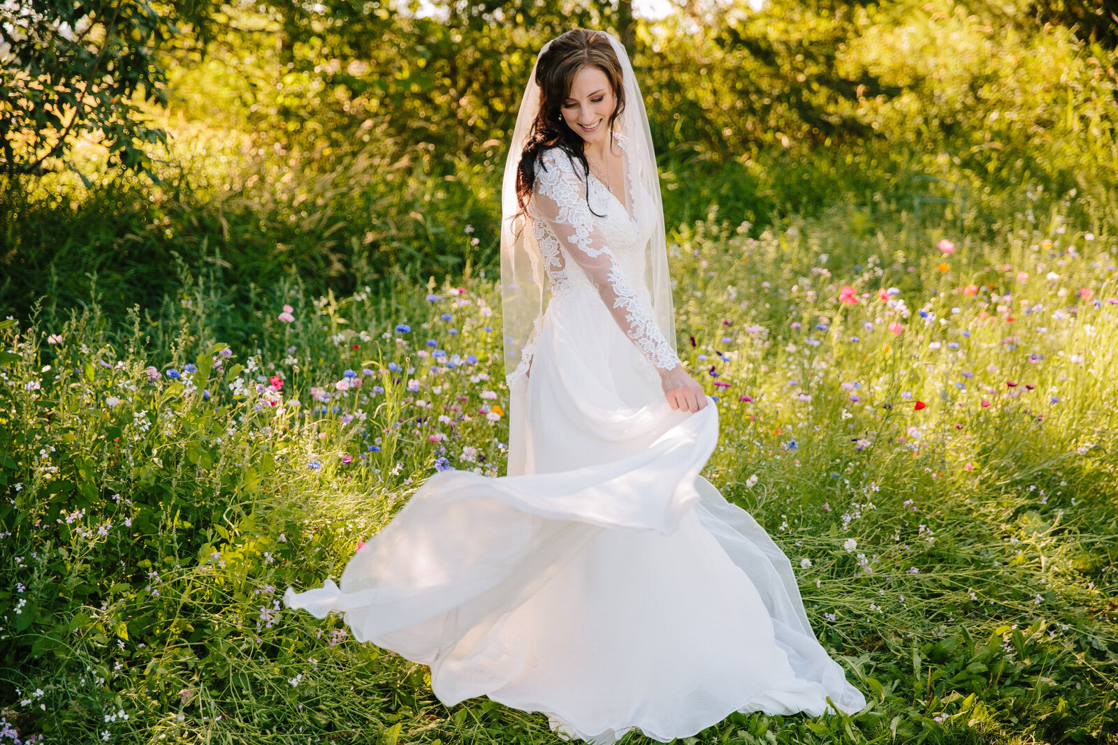Jackson Hole photographers capture bride swinging gown during waterfall bridals