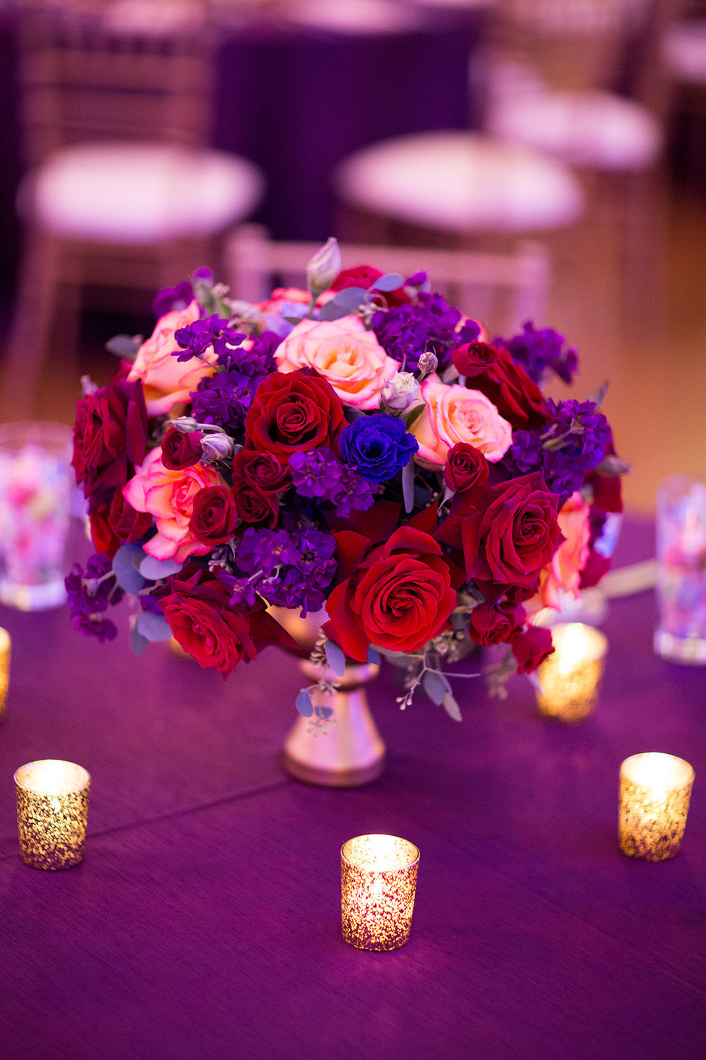 reception centerpiece with purple and pink flowers