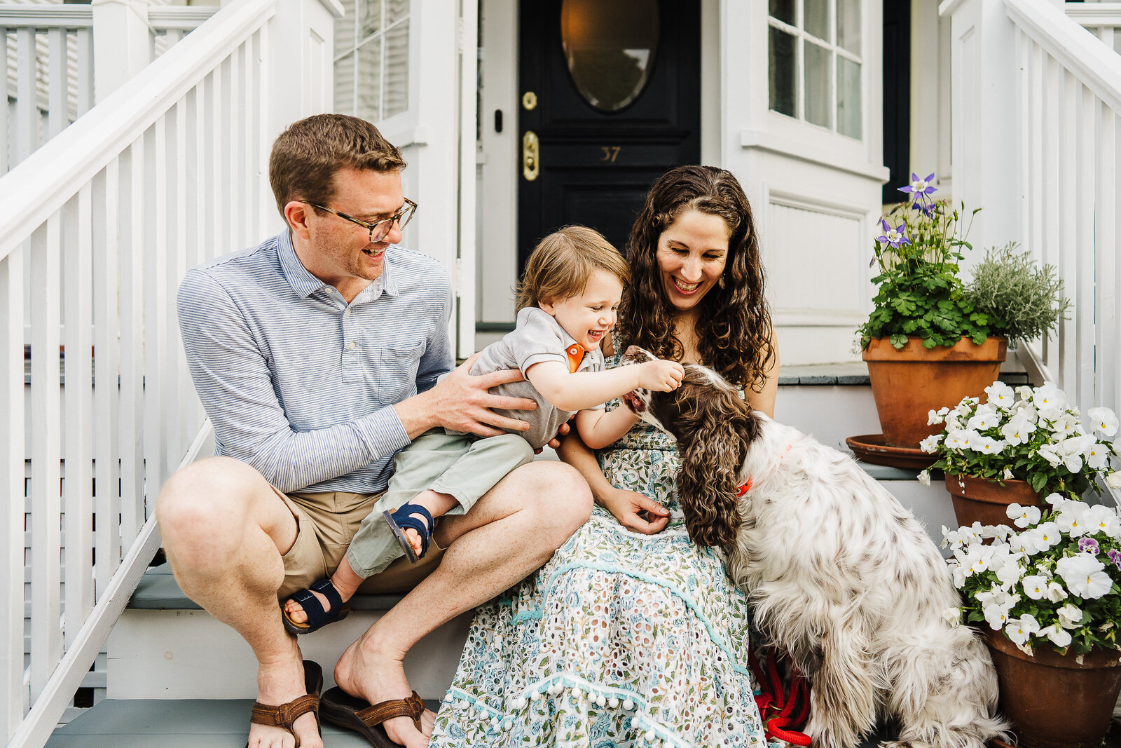 family on front steps with dog