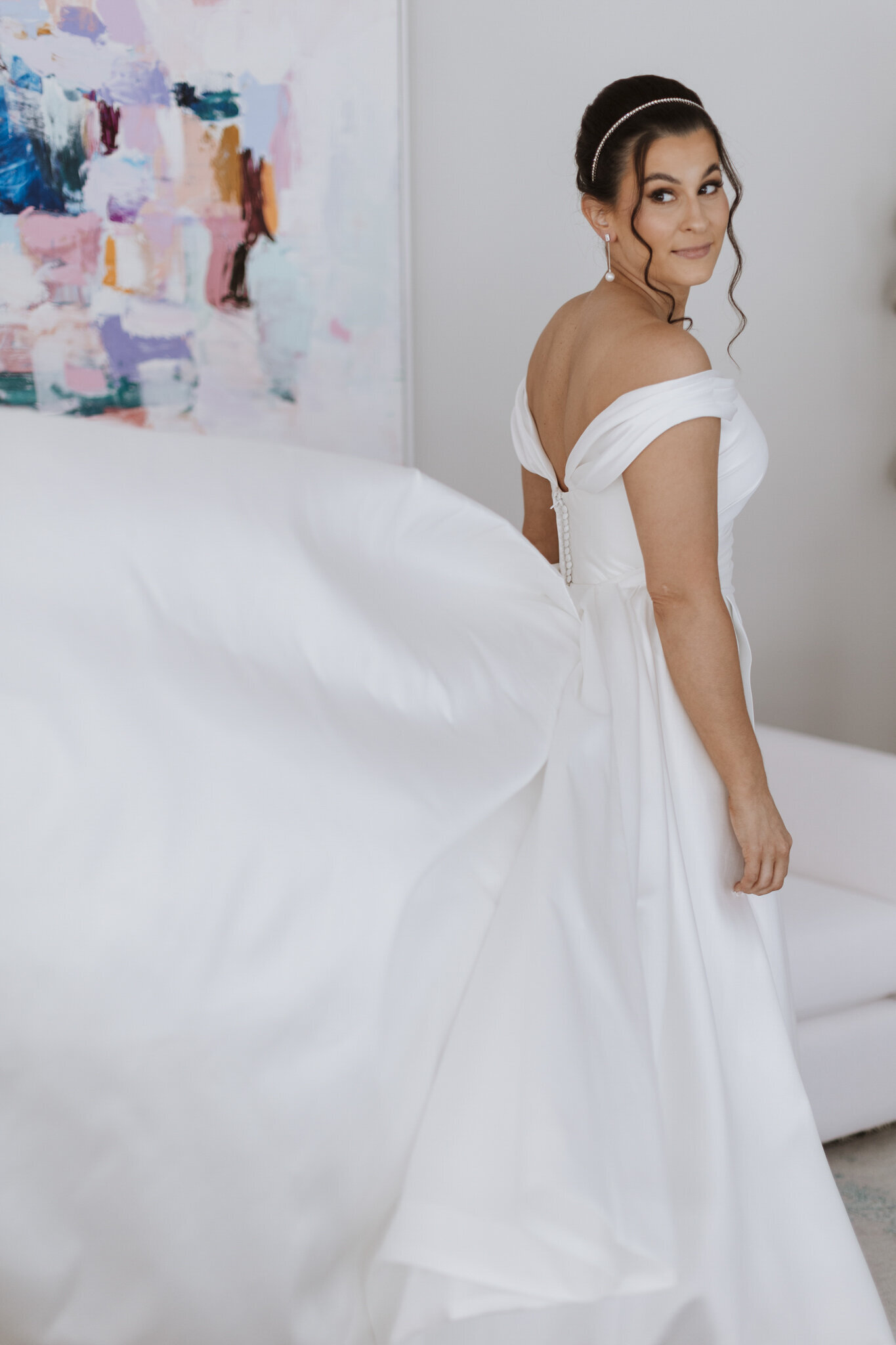 A bride standing in a white wedding dress by melbourne wedding photographer Ada and Ivy