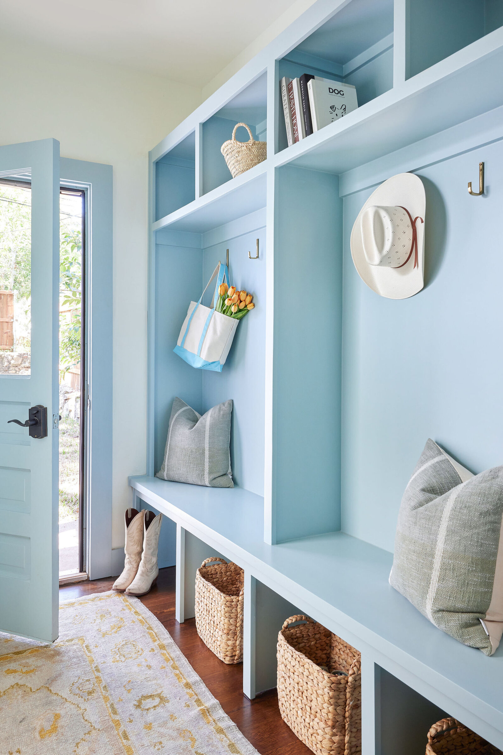 cocoloba homes cockrell ave blue painted mudroom with accent rug and doorway