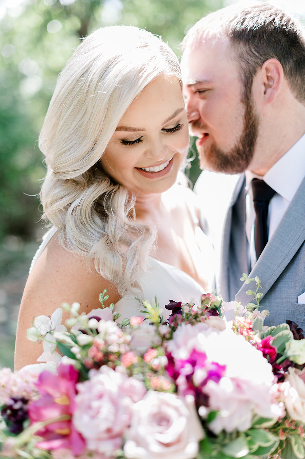 Bride and groom pose with pink bouquet taken by the Best Boise Wedding Photographers
