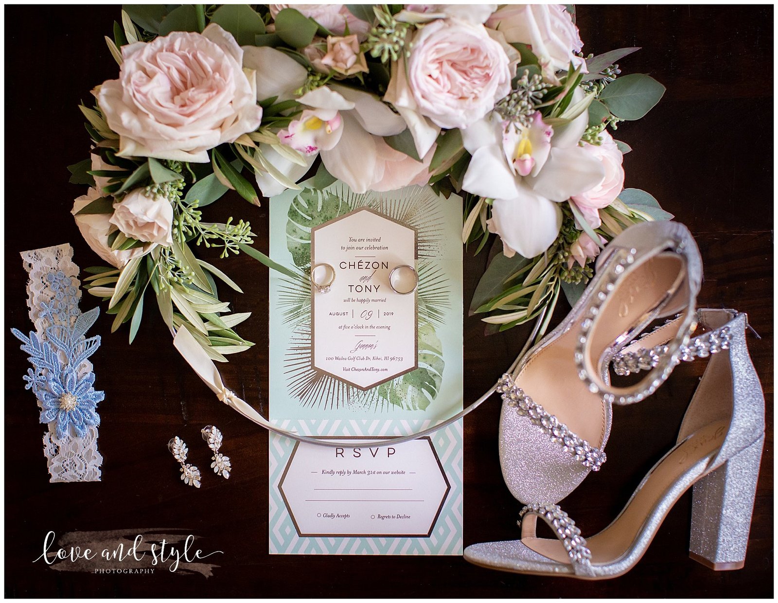 Detail shot of wedding invitation with shoes and jewelry
