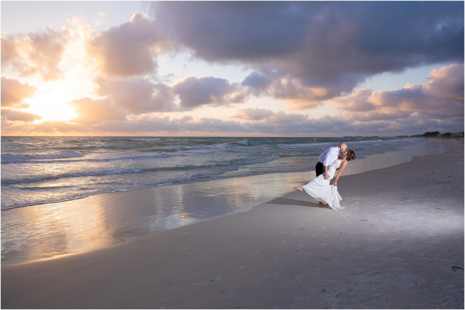 Bride and Groom kissing on the beach during sunset at Anna Maria Island, Florida