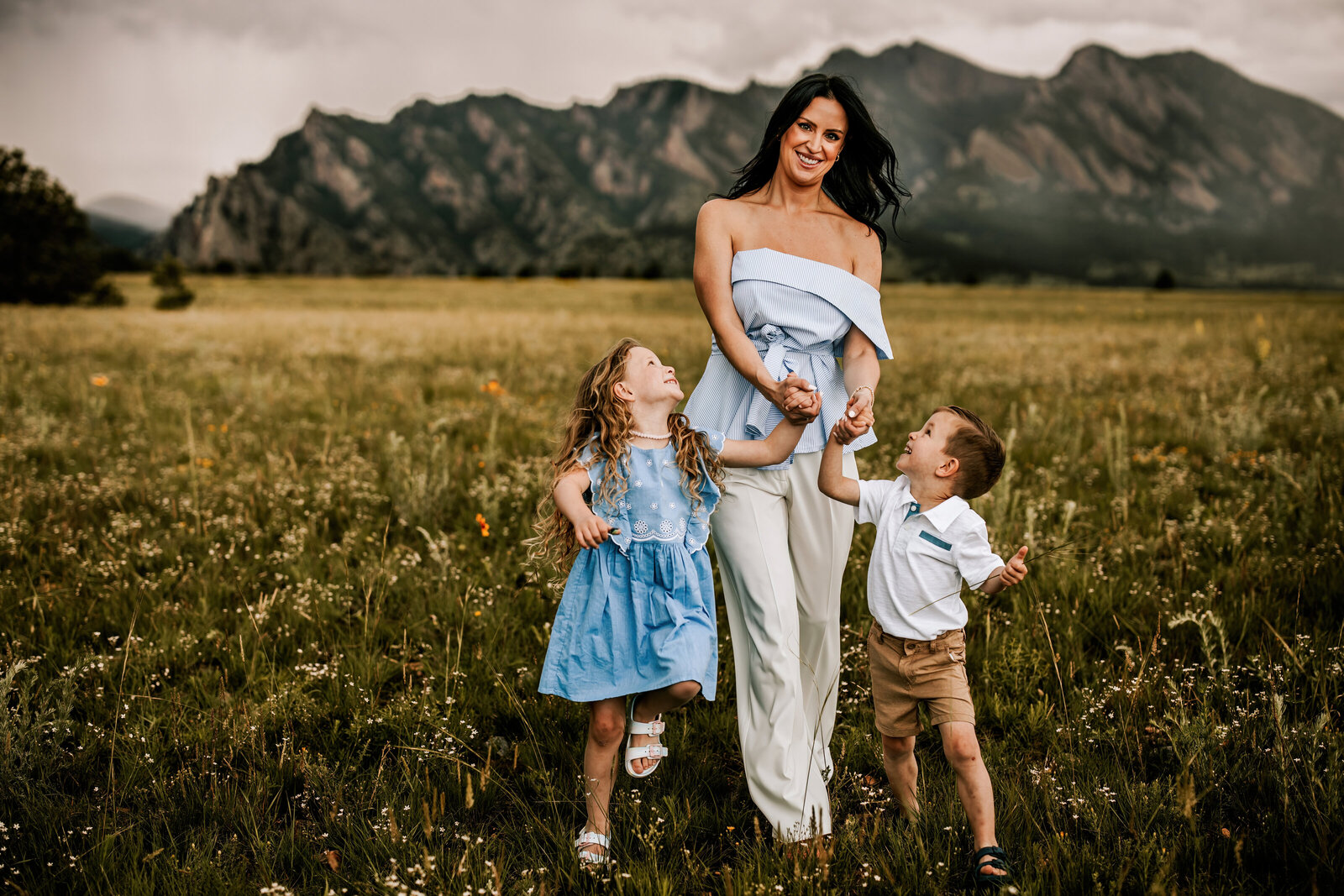 mom walking with two kids during family photo session in boulder colorado