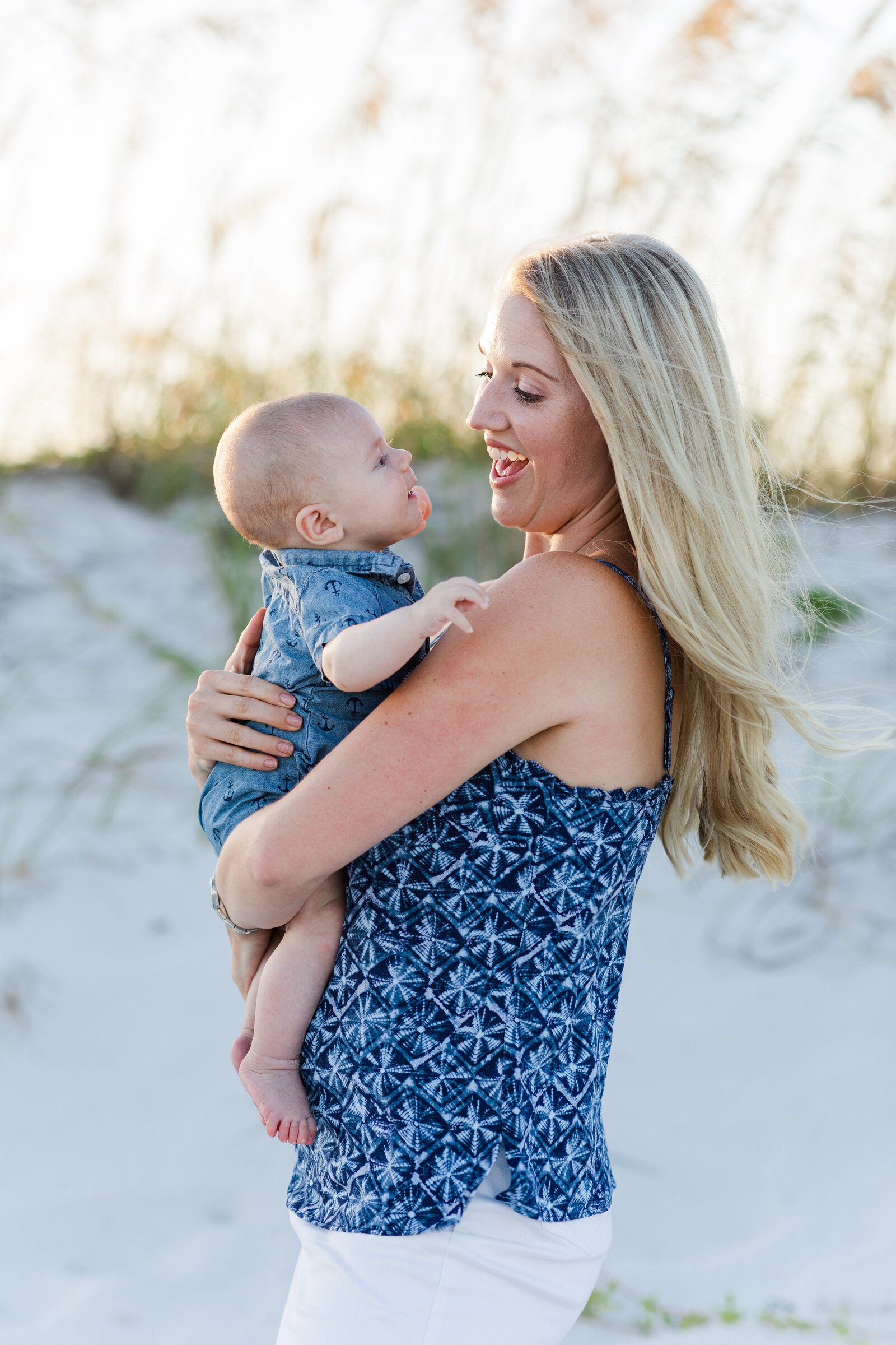 Mother embracing newborn son on Pensacola Beach