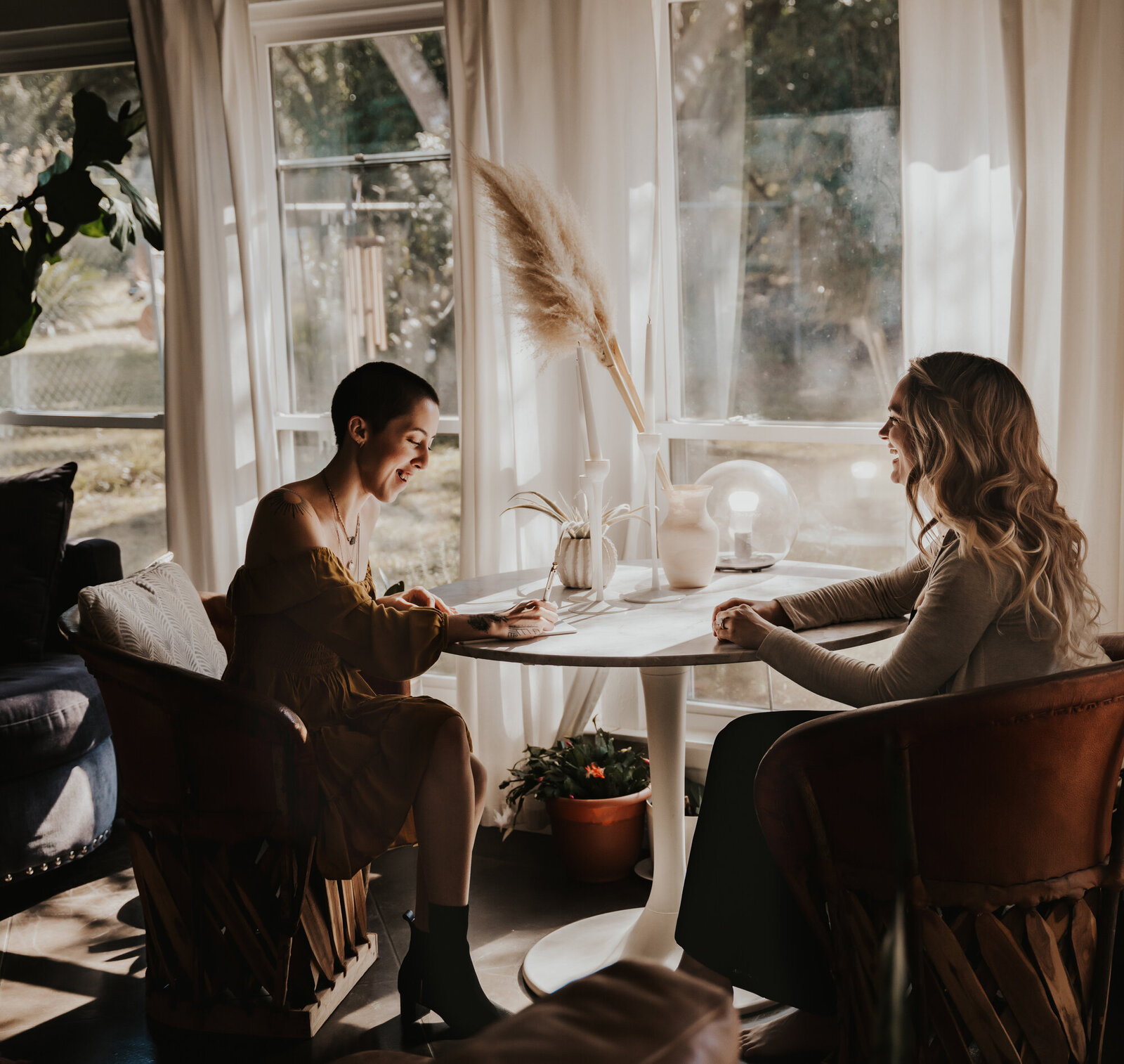 Branding Photographer, two women sit at a table talking, one woman is taking notes