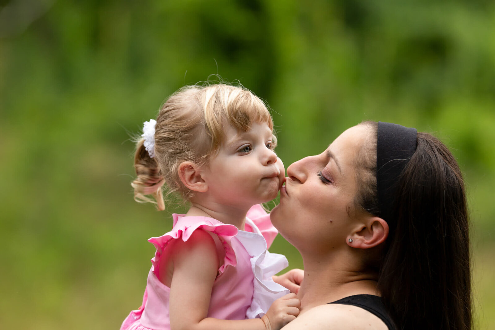 Mothe and daughter sharing a kiss