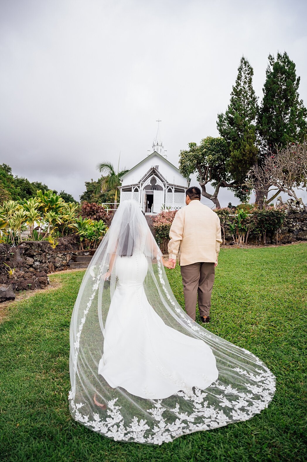 bride and groom walking to their church wedding in Kona