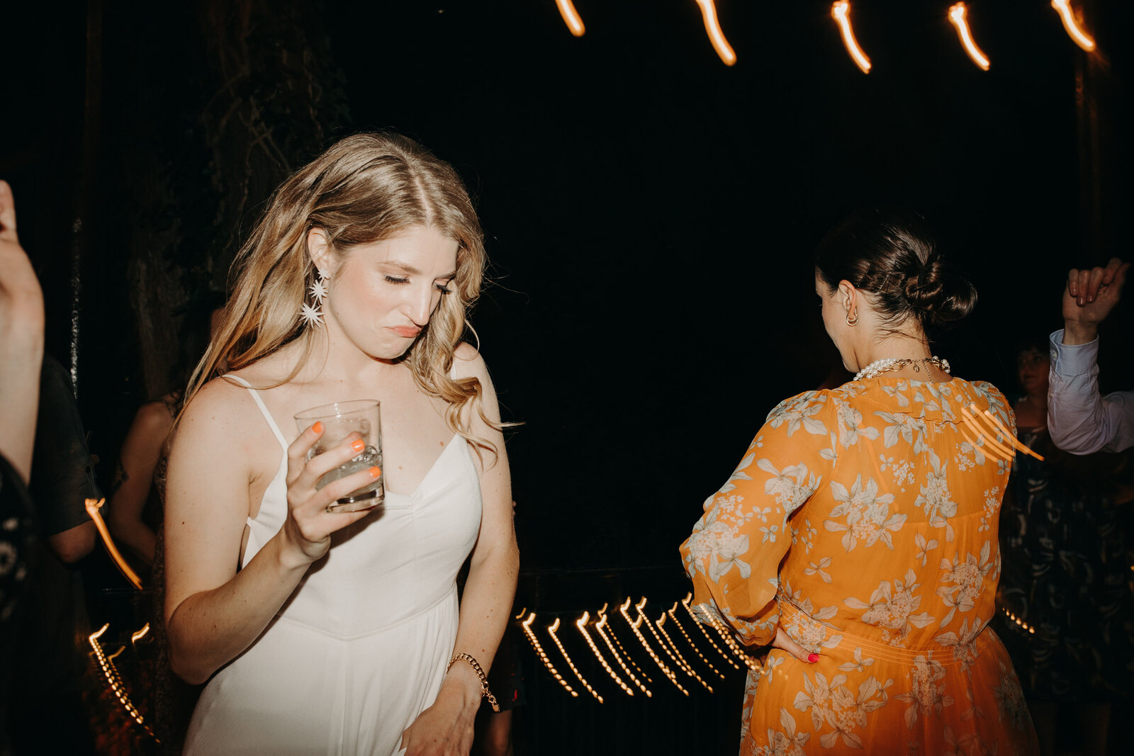 Bride dancing with drink in hand