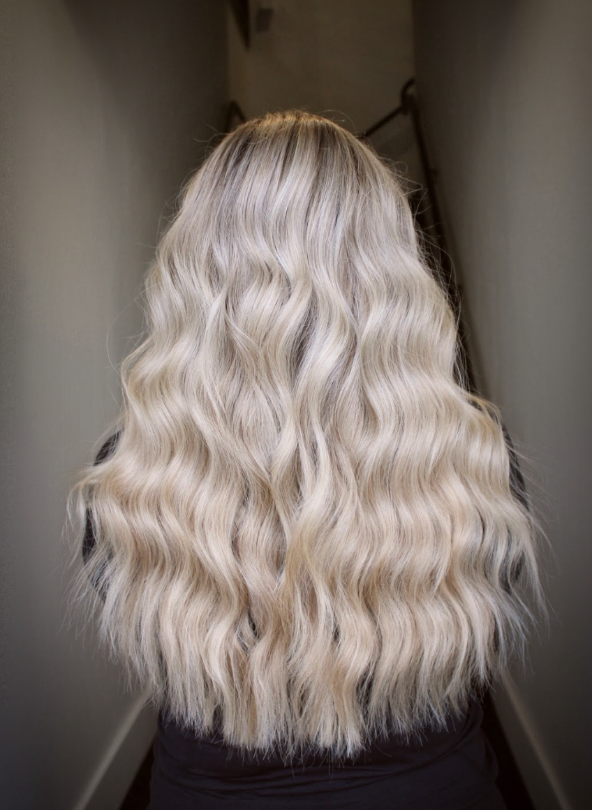 Thick, lustrous icy blonde curls from the back, full of volume