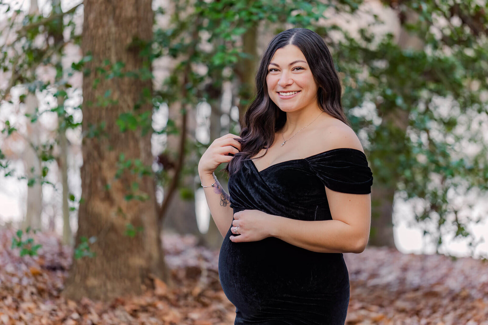 A Burke, VA maternity session of a woman in a black dress.