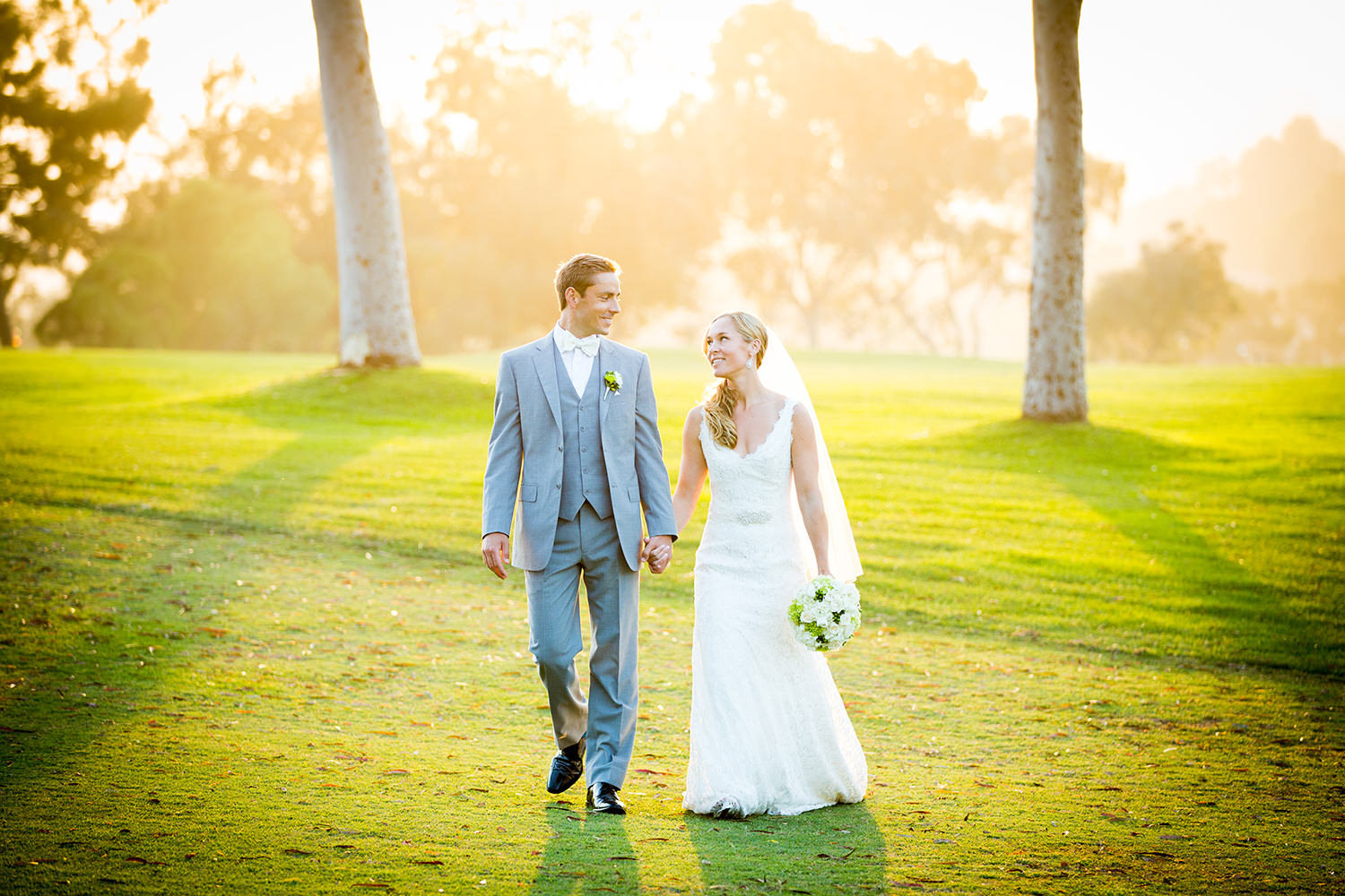 bride and groom walking golf cousre